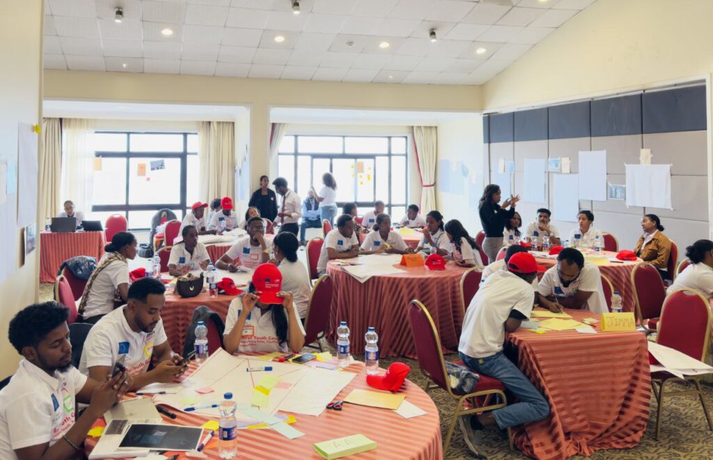 An image of youth in circle setting, actively engaging in discussion.